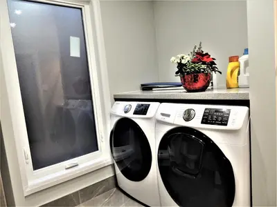 a white washing machine sitting next to a window at iResidence in Toronto - Fantastic Vacation Home with Breakfast in Toronto