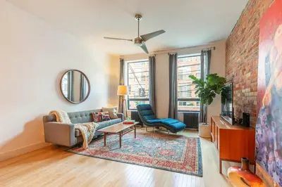 a living room with a couch and a tv at Gorgeous Park House w Parking on Queen West in Toronto