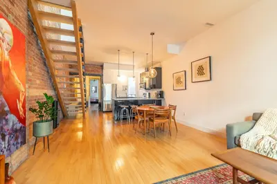 a living room and dining room with a table and chairs at Gorgeous Park House w Parking on Queen West in Toronto