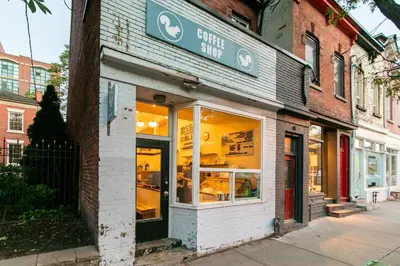 a store front of a store on a city street at Gorgeous Park House w Parking on Queen West in Toronto