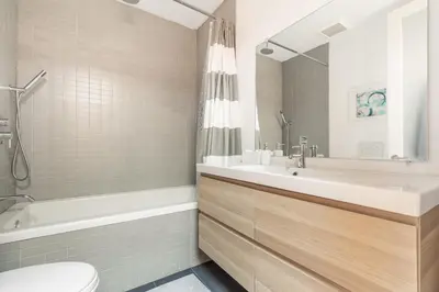 a bathroom with a sink and a tub and a toilet at Gorgeous Park House w Parking on Queen West in Toronto