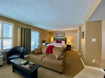 a living room with a bed and a couch at Quiet Hillside Studio - Wifi, Pool, Close to The Village in Blue Mountains