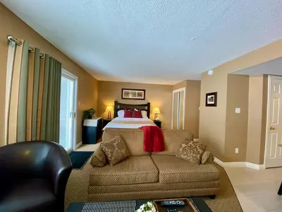 a living room with a bed and a couch at Quiet Hillside Studio - Wifi, Pool, Close to The Village in Blue Mountains