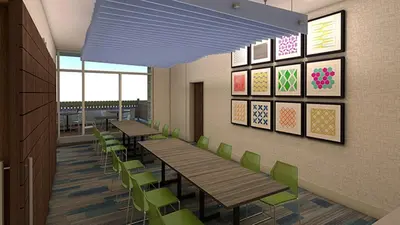 a cafeteria with wooden tables and green chairs at Holiday Inn Express & Suites - Aurora by IHG in Aurora