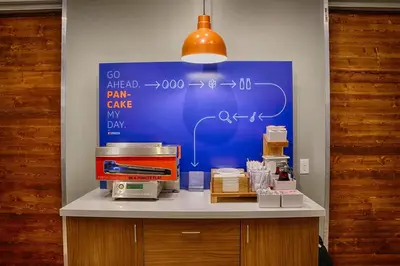 a table with a blue board with auclearuclearuclear at Holiday Inn Express & Suites - Aurora by IHG in Aurora