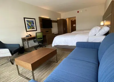 a hotel room with a bed and a desk at Holiday Inn Express & Suites - Aurora by IHG in Aurora