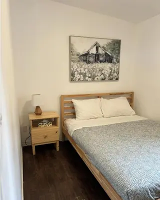 a bedroom with a bed and a picture of a house at Saga Resort in Wasaga Beach