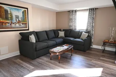 a living room with a couch and a coffee table at Elgin Suite in Niagara Falls