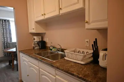 a kitchen with a sink and a counter top at Elgin Suite in Niagara Falls