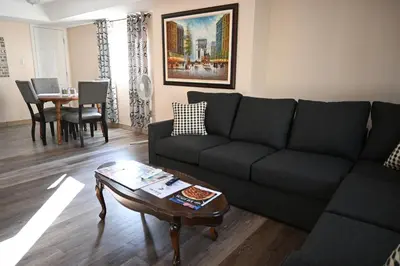 a living room with a couch and a table at Elgin Suite in Niagara Falls