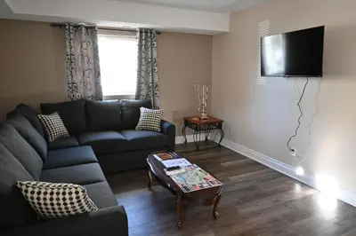 a living room with a couch and a table at Elgin Suite in Niagara Falls