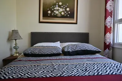 a bedroom with a bed with two pillows on it at Centennial Suite in Niagara Falls