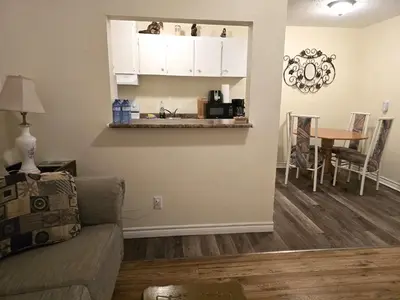 a living room with a couch and a table at Capitol Suite in Niagara Falls