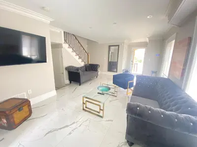 a living room with a couch and a table at Luxury Adventure, Rutherford Go station & Wonderland in Vaughan