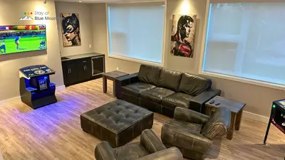 a living room with a couch and a tv at Orchard Run Chalet in Blue Mountains