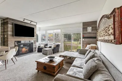a living room with a couch and a fireplace at 2 BR Ski In Out at Cachet Crossing, Sleeps 8 in Blue Mountains