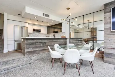 a dining room with a glass table and white chairs at 2 BR Ski In Out at Cachet Crossing, Sleeps 8 in Blue Mountains
