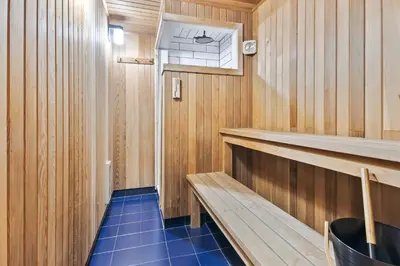 a small sauna with a blue floor and wooden walls at 2 BR Ski In Out at Cachet Crossing, Sleeps 8 in Blue Mountains