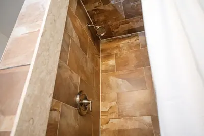 a shower with a glass door in a bathroom at Blue Mountain, 3 BR - 108 Mountain Walk Chalet in Blue Mountains