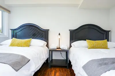 two beds sitting next to each other in a room at Blue Mountain, 3 BR - 108 Mountain Walk Chalet in Blue Mountains