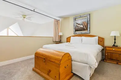 a bedroom with a large bed and a window at 2BR Slopeside in Chateau Ridge Blue Mountains in Blue Mountains