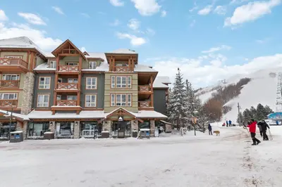 a building on a ski slope in the snow at 2BR Slopeside in Chateau Ridge Blue Mountains in Blue Mountains