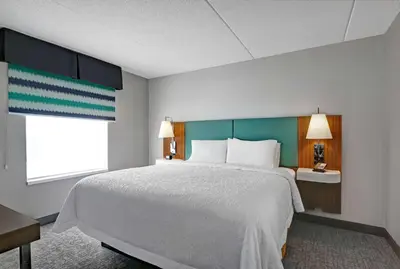 a bedroom with a large bed and a window at Hampton Inn & Suites Belleville in Belleville