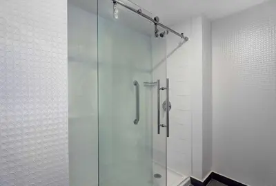 a shower with a glass door in a bathroom at Hampton Inn & Suites Belleville in Belleville