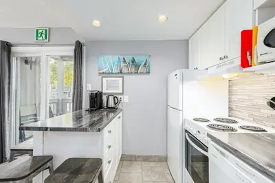 a kitchen with white cabinets and a white refrigerator at Blue Mountain Hideaway at North Creek Resort in Blue Mountains