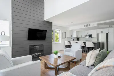 a living room with a couch and a fireplace at Ski in Ski Out Condo at Blue Mountain Close to Village in Blue Mountains