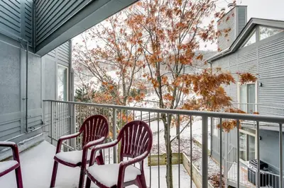 two chairs on a balcony with snow on them at Ski in Ski Out Condo at Blue Mountain Close to Village in Blue Mountains