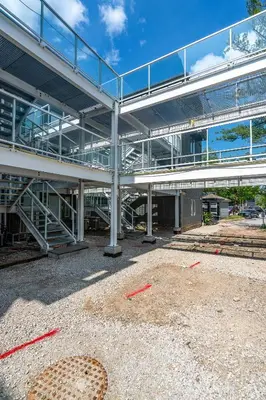 a large metal building with a stairway in front of it at Ski in Ski Out Condo at Blue Mountain Close to Village in Blue Mountains