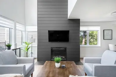 a living room with a fireplace with a tv at Ski in Ski Out Condo at Blue Mountain Close to Village in Blue Mountains
