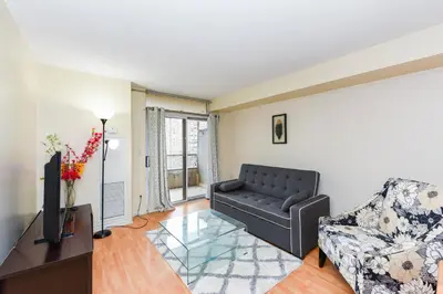 a living room with a couch and a television at PlanURstay - Ideal 2 BR & 2BTH 3888 Duke of York Blvd in Mississauga