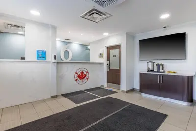 a large room with a large flat screen tv on the wall at Studio 6 Toronto - Mississauga with Kitchenettes in Mississauga