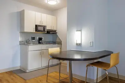 a small kitchen with a table and chairs in a room at Studio 6 Toronto - Mississauga with Kitchenettes in Mississauga