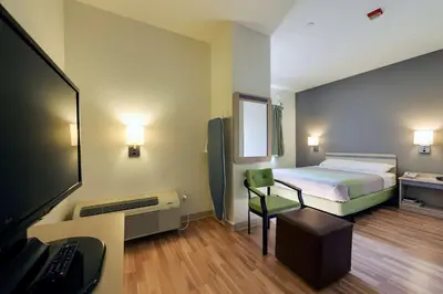 a room with a bed and a desk with a computer at Studio 6 Toronto - Mississauga with Kitchenettes in Mississauga