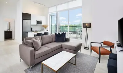 a living room with a couch and a table at Muskoka Bay Resort in Gravenhurst