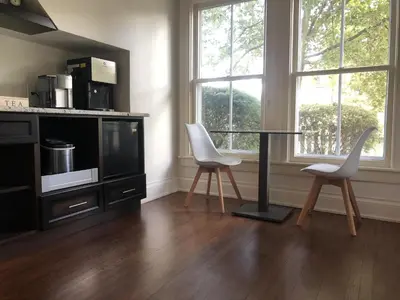 a kitchen with a table and two white chairs at Harrogate House Inn in Niagara on the Lake
