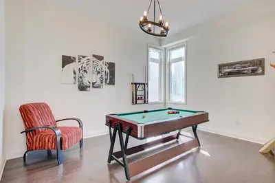 a room with a pool table and a chair at Grand Waterfront Retreat under 1hr from Toronto in Bowmanville
