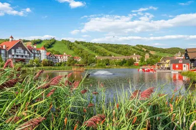 a town with a river with boats in the water at Ski In Out 1 BR, Sleeps 6 Cachet Crossing in Blue Mountains