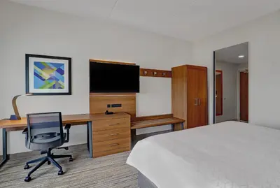 a hotel room with a bed and a desk with a computer at Holiday Inn Express & Suites - Port Elgin in Port Elgin