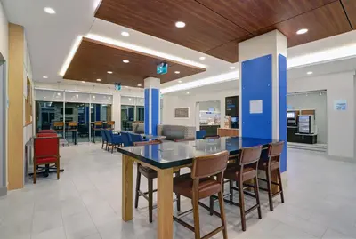 a dining room with a blue table and chairs at Holiday Inn Express & Suites - Port Elgin in Port Elgin