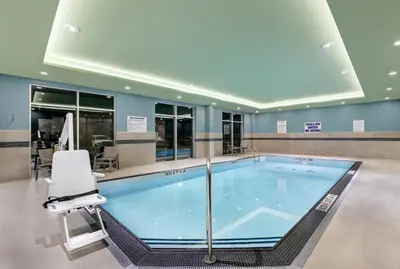 a large swimming pool in a hospital room with a chair at Holiday Inn Express & Suites - Port Elgin in Port Elgin