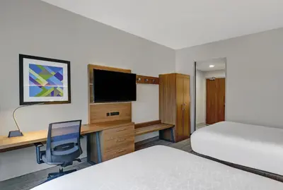 a hotel room with two beds and a desk with a computer at Holiday Inn Express & Suites - Collingwood in Collingwood
