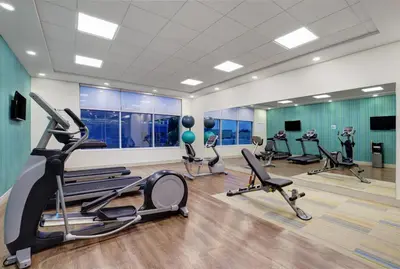 a gym with several treadmills and elliptical machines at Holiday Inn Express & Suites - Collingwood in Collingwood