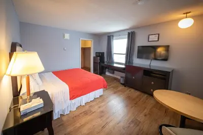 a hotel room with a bed and a flat screen tv at Choice Inn by the falls in Niagara Falls