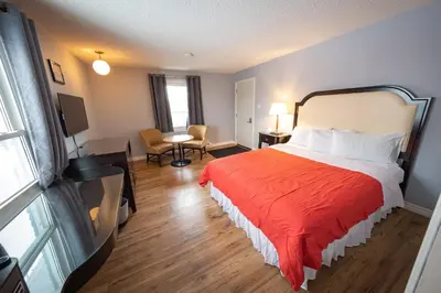 a hotel room with a bed with a red blanket at Choice Inn by the falls in Niagara Falls