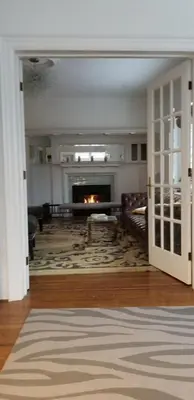 a living room with a fireplace and a couch at The Jane Toronto in Toronto