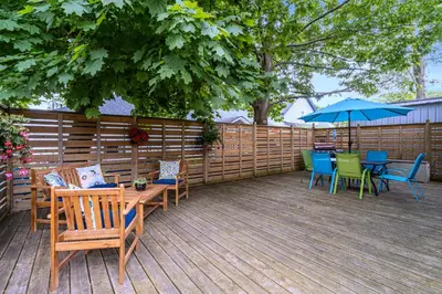 a patio with a table and chairs and an umbrella at Sandy Cove Cottage in Crystal Beach
